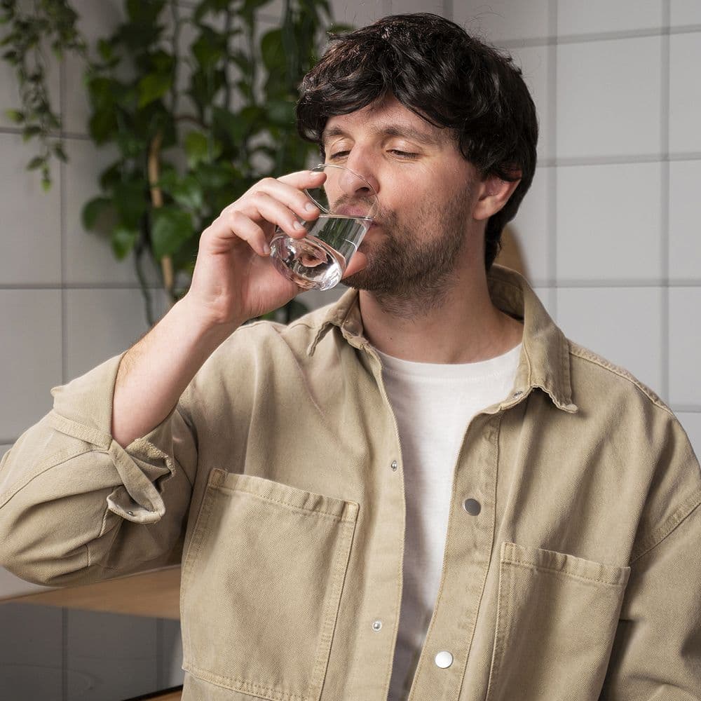 A person drinking a glass of water.