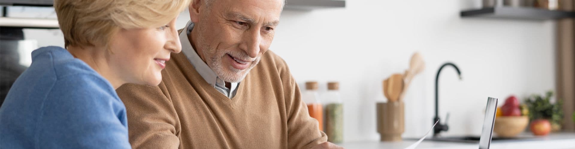 Two people look over each others' shoulder.